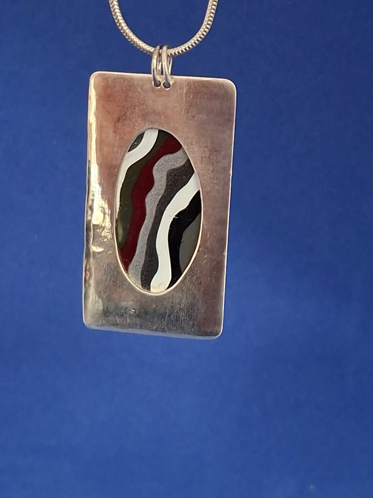 Large Oval Shaped Fordite on Rectangular Silver Pendant