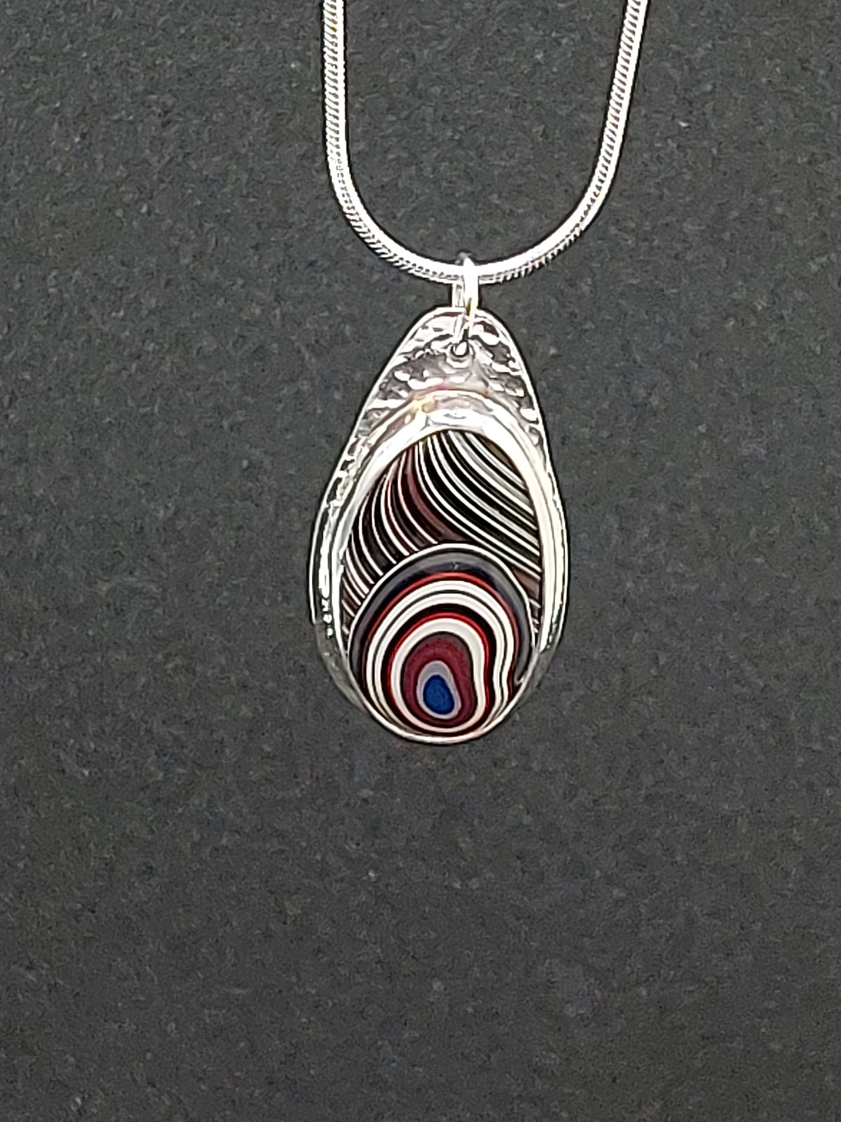 Oval Shaped Fordite Silver Pendant