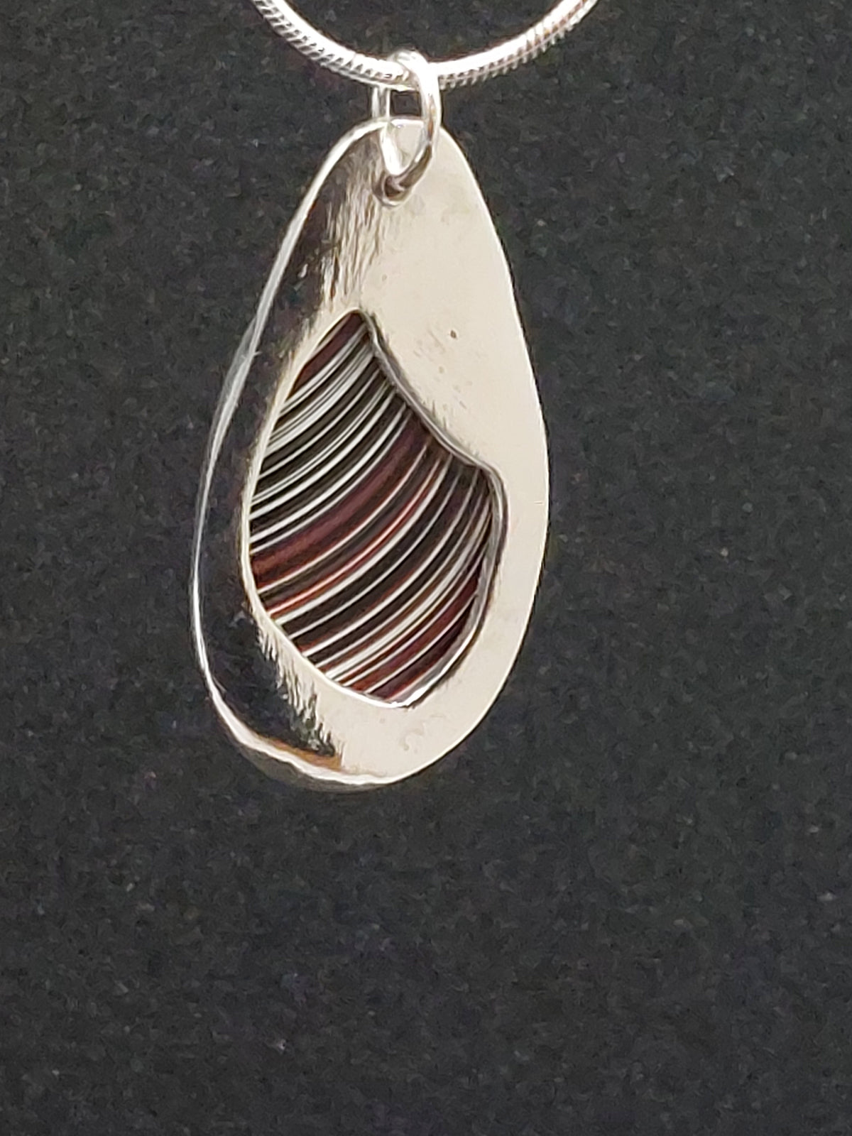 Oval Shaped Fordite Silver Pendant