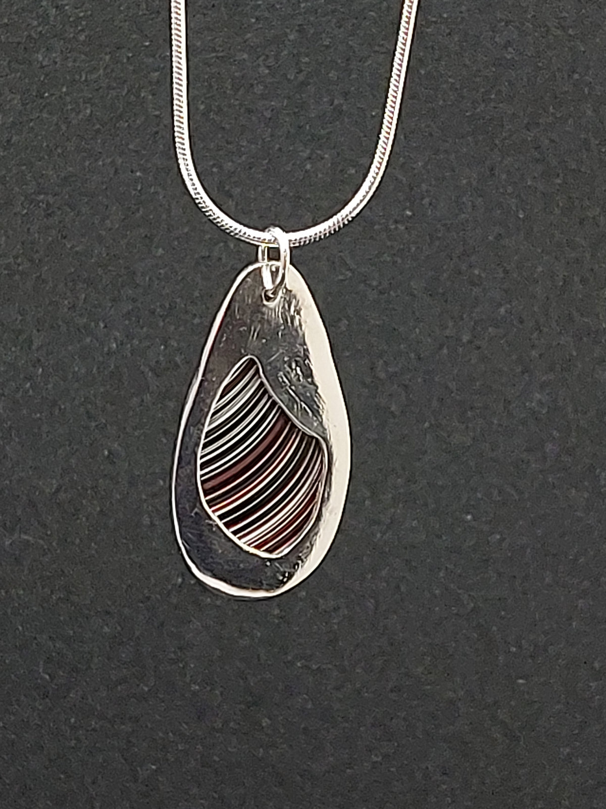 Oval Shaped Fordite Silver Pendant
