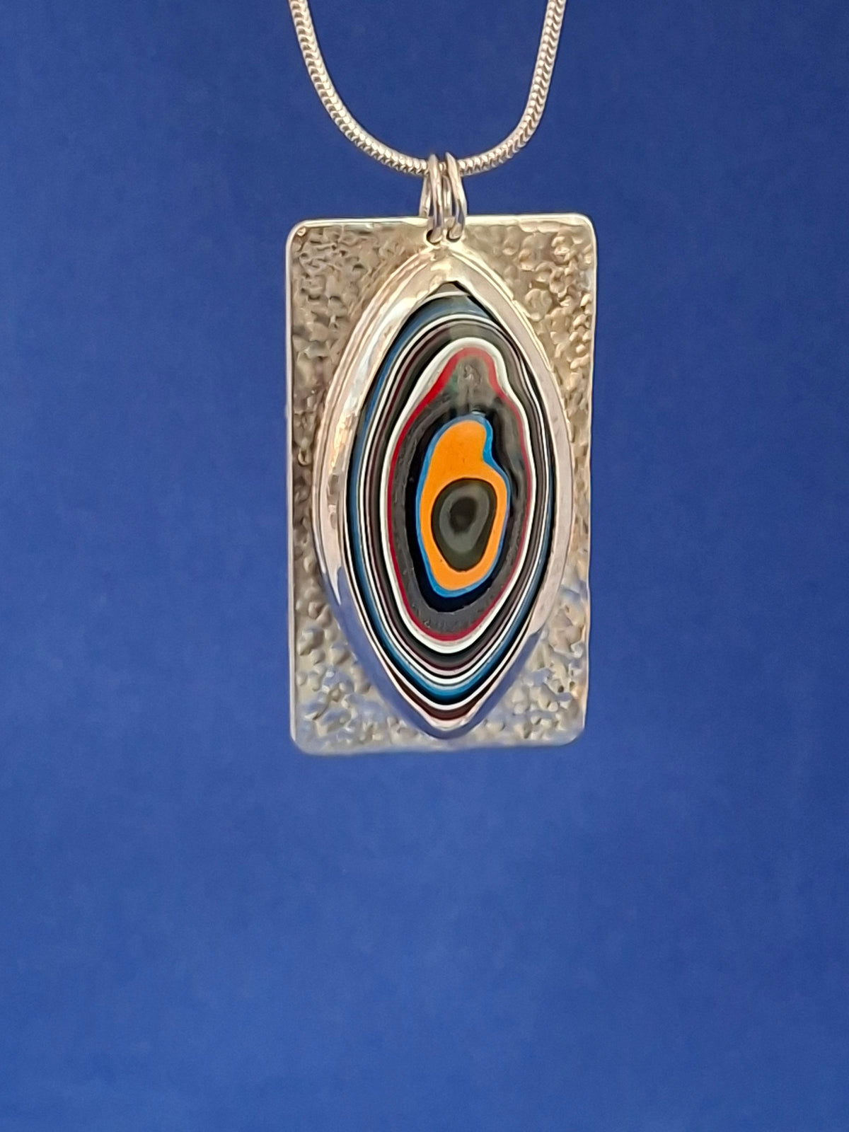 Large Oval Shaped Fordite on Rectangular Silver Pendant